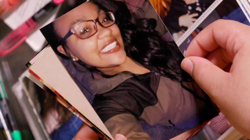 A hand holds a photo of Rose Salveson when she was 18 and experiencing homelessness. 