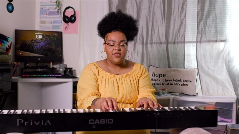 Rose Salveson plays the keyboard at her home. 