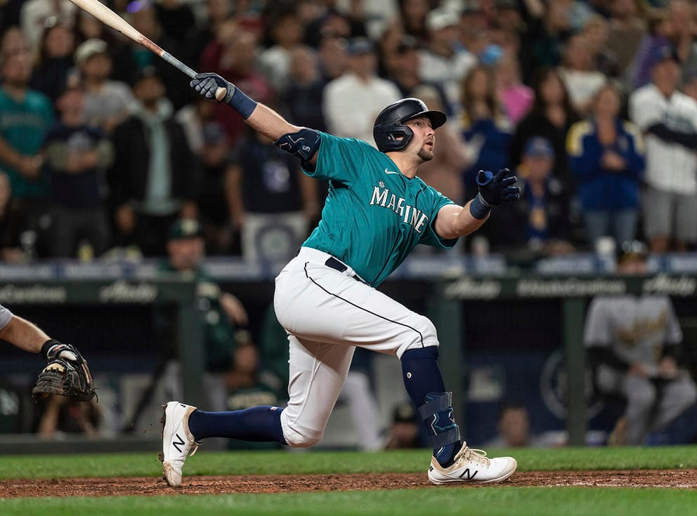 Man with a baseball bat completing a mighty swing