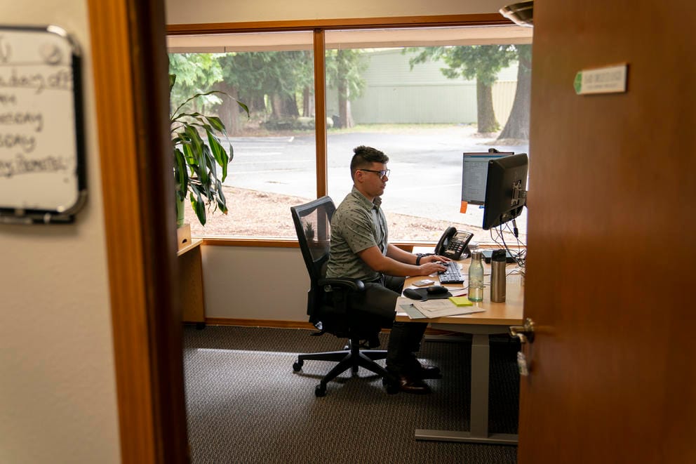 An eviction mediator works in his office.
