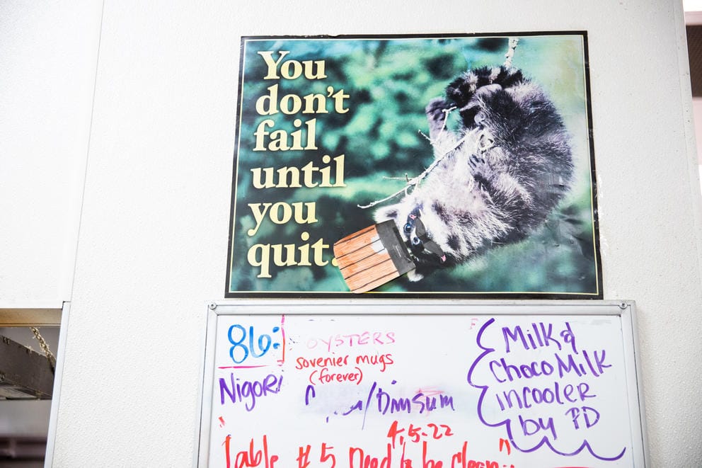 A poster hangs on a wall reading 