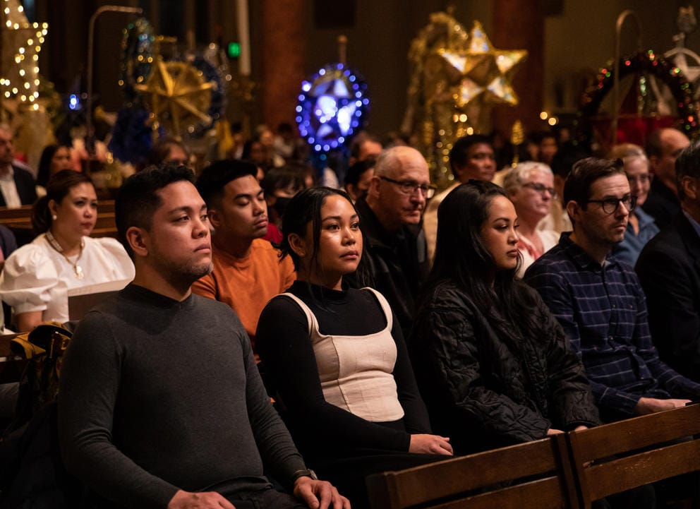 Parishioners sit in pews in church