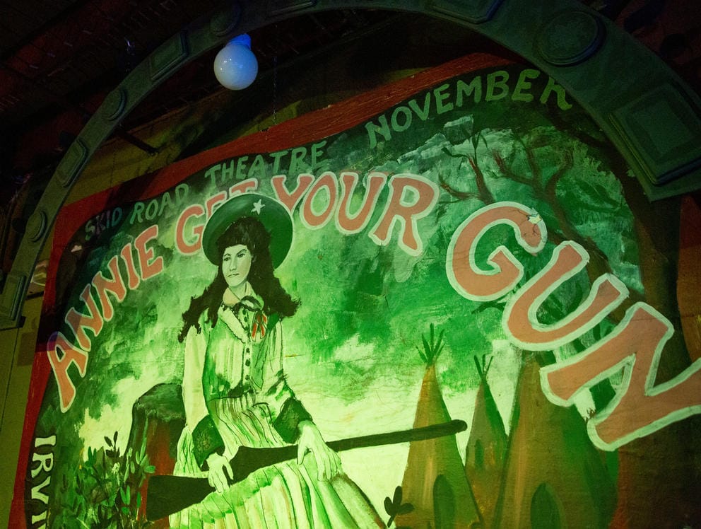Painted mural depicting a woman with a shotgun reads