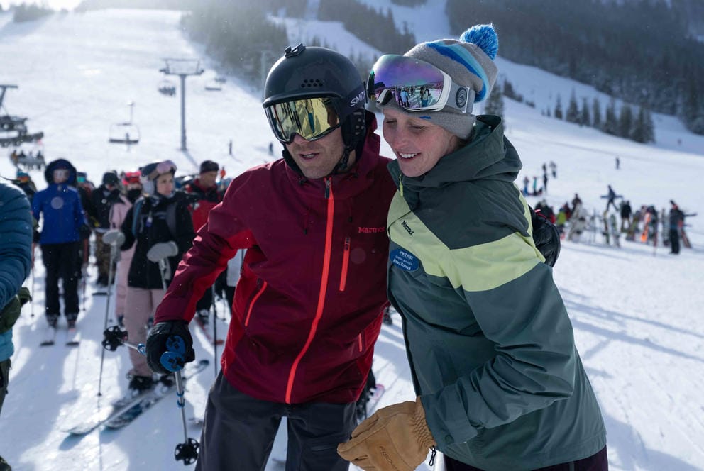 Two people hugging at ski lift