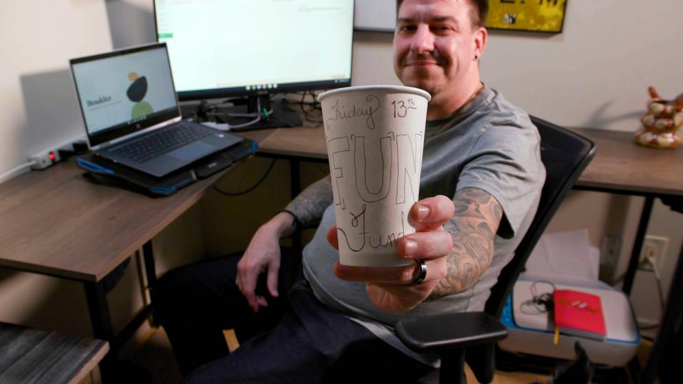A man holds a cup with 
