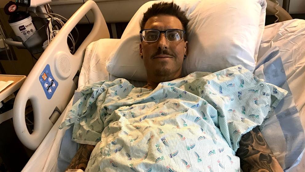 A man lies in a hospital bed