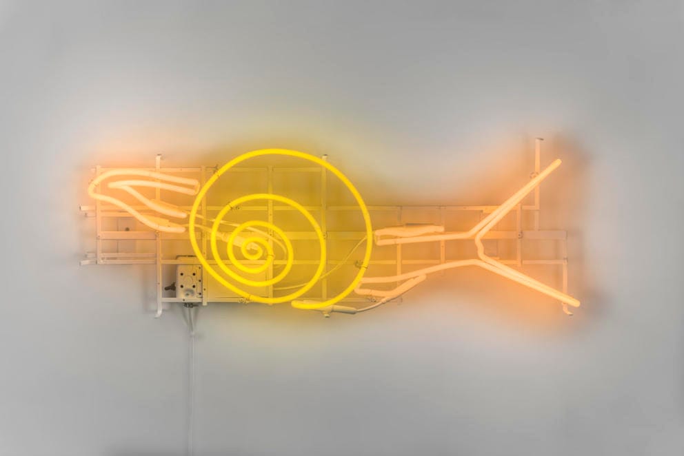 a yellow snail made of neon