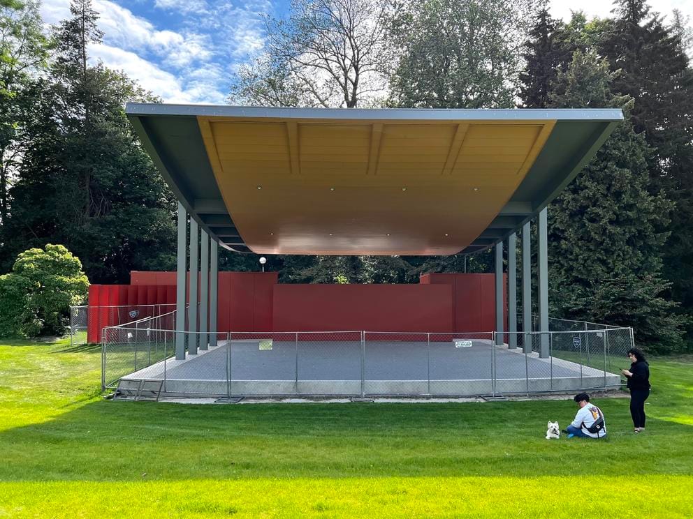 an outdoor stage with swooping roof