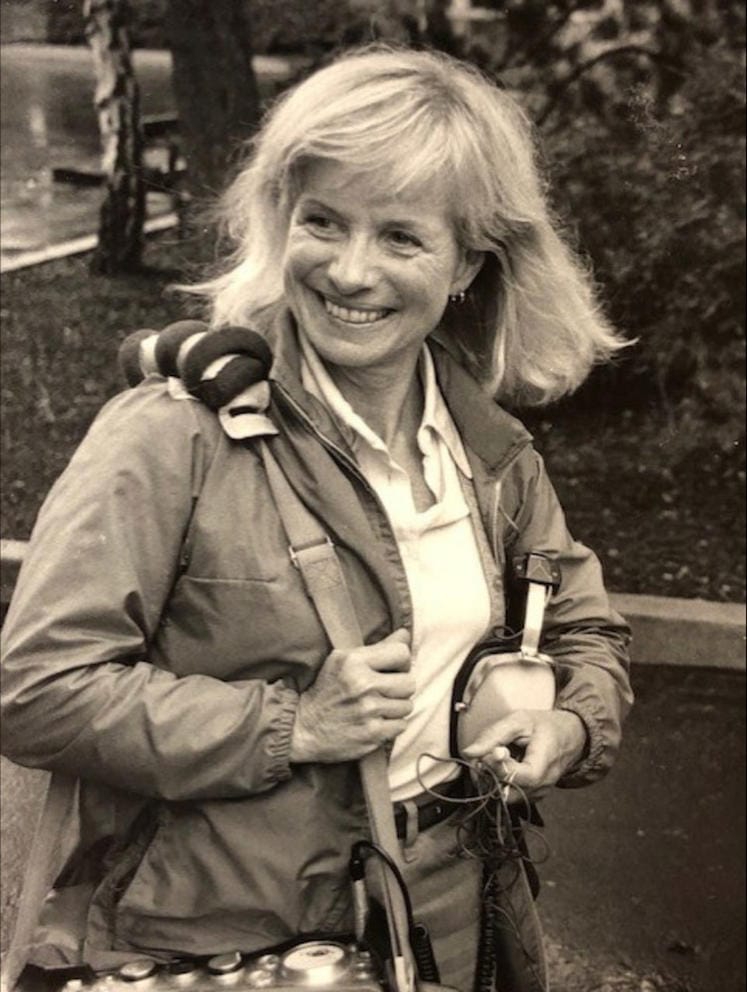 black and white photo of a blond woman with a news camera