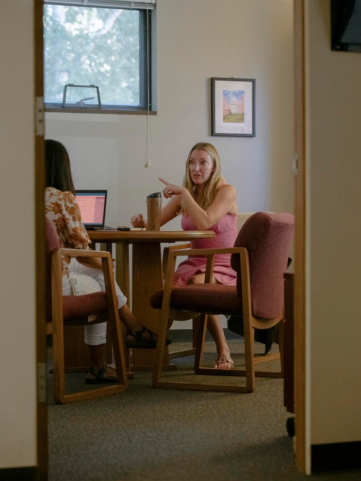 Women seated talking in office