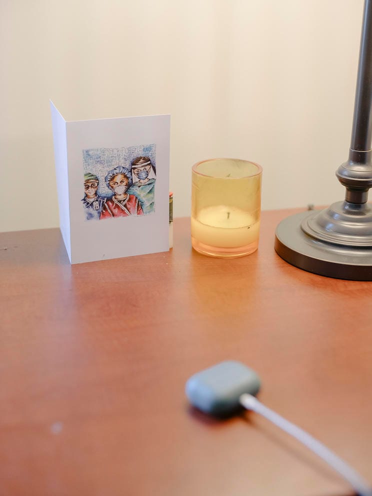 Greeting card and candle rest on a desktop