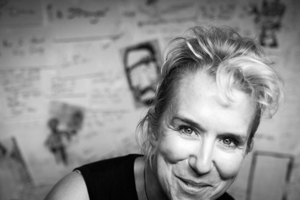 a black and white photo, close up of a woman with her hair pulled back