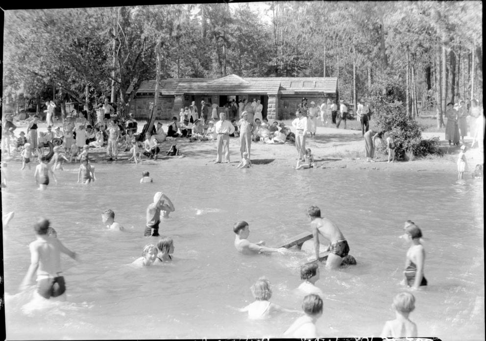 Many people in the water at a beach