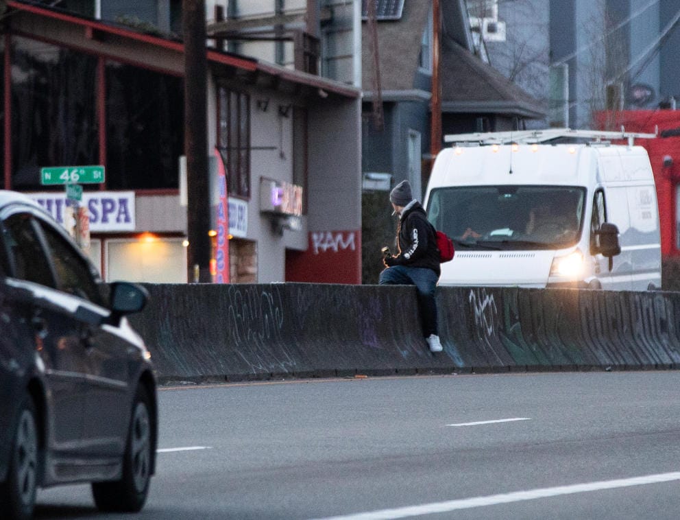 A pedestrian crosses a dangerous section of Aurora Avenue North