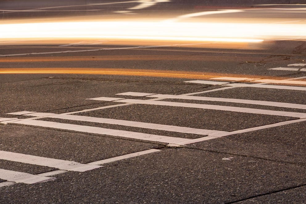 Cars pass a crosswalk on Aurora Avenue North where a pedestrian was hit.
