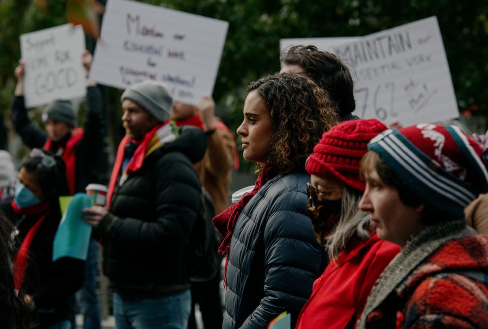 a group of people rallying outside seattle city hall