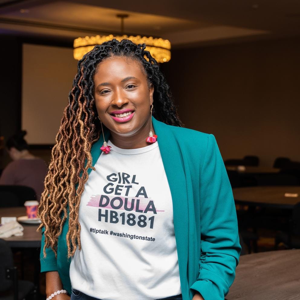 Stephaine Courtney, the founder of Shades of Motherhood in Spokane, with a shirt that reads