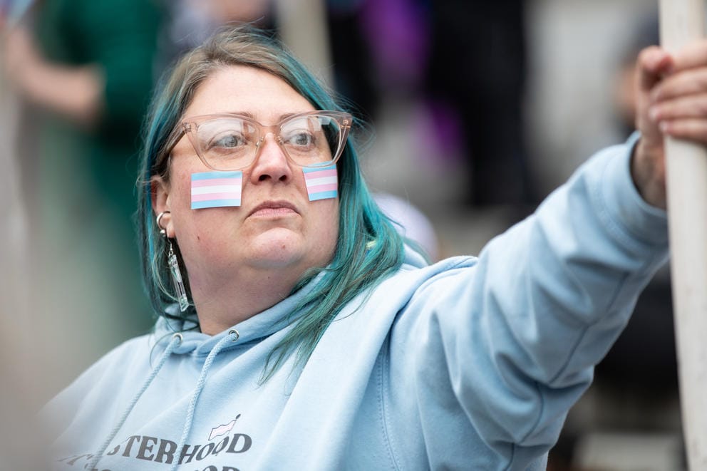 Jenna Kemp listens to speeches supporting transgender youth 