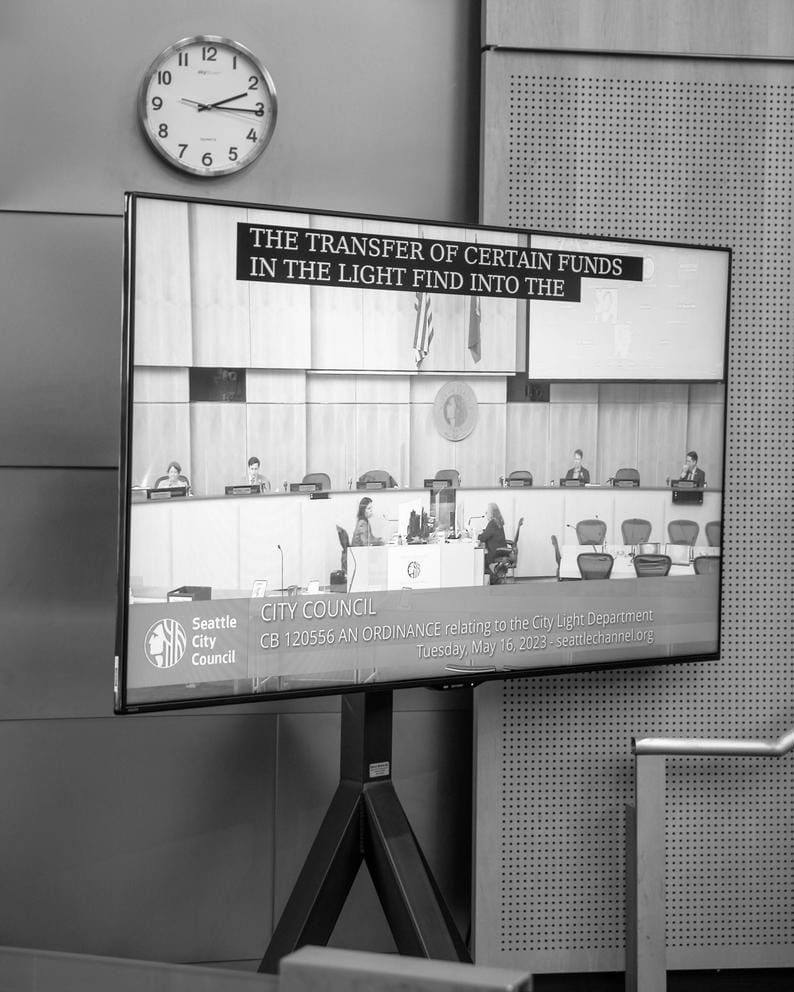 a television broadcasting a city council meeting from within city hall