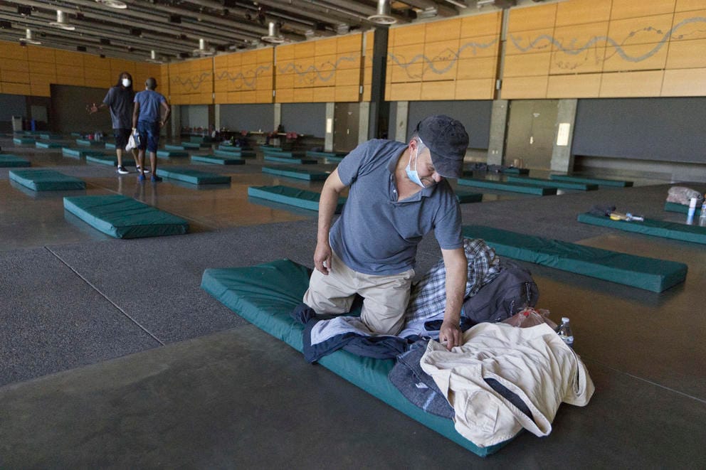 Roberto Cedomio prepares his bed at a cooling shelter run by the Salvation Army at the Seattle Center during a record-breaking heat wave that hit the Pacific Northwest in June 2021.
