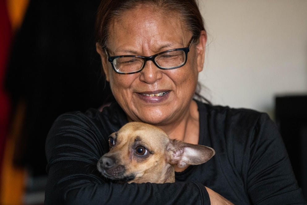 Jacqueline Gabriel holds her dog, Queenie
