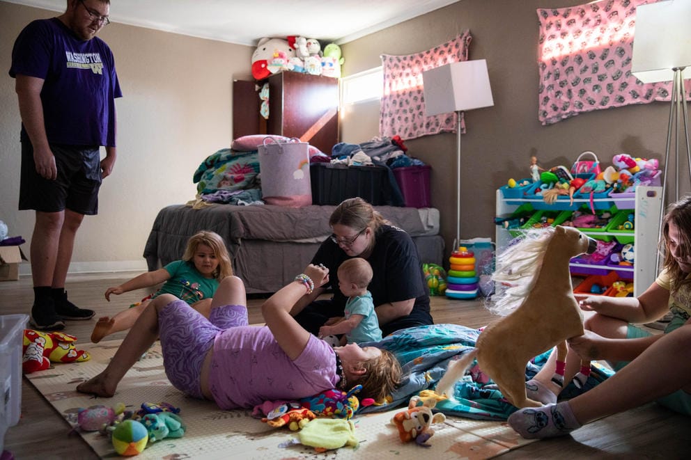 The Blackledge family hangs out in the girls’ room at Neighborhood Apartments
