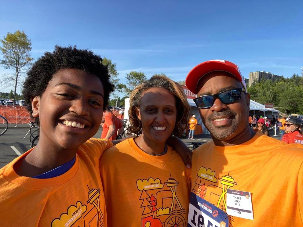 Hall, son Brent Jr. and wife Elsa smile for a photo