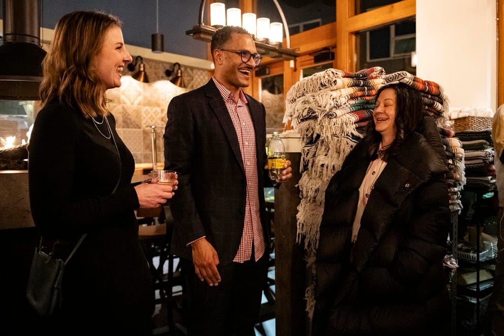 a man talks to two women at an election night party