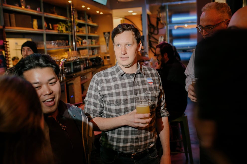 a man holding a beer