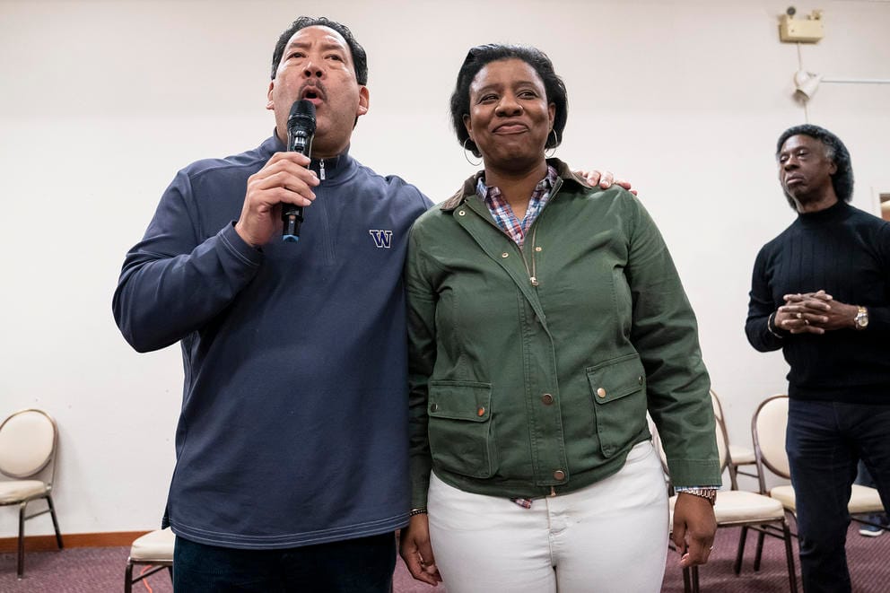 a man and woman stand together on a stage