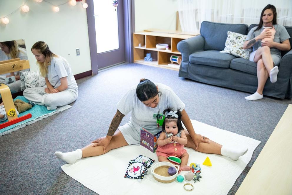 Mothers and their babies play in a nursery room