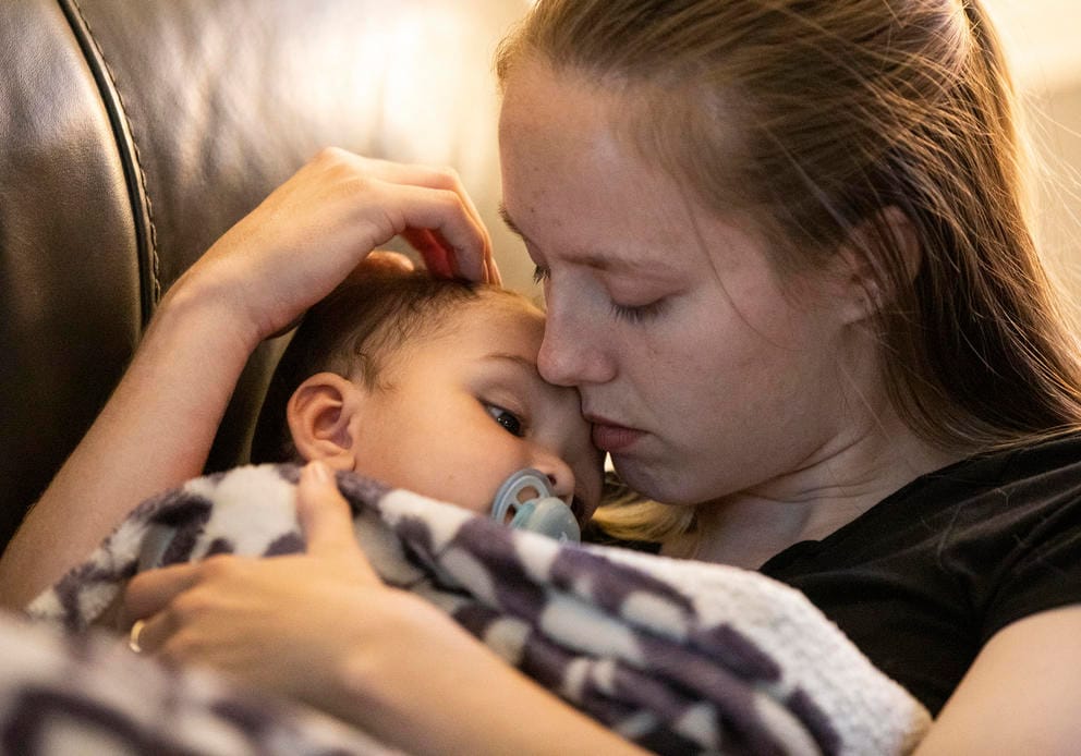 A close up: Paige Zorn’s child Zaylin falls asleep in her arms