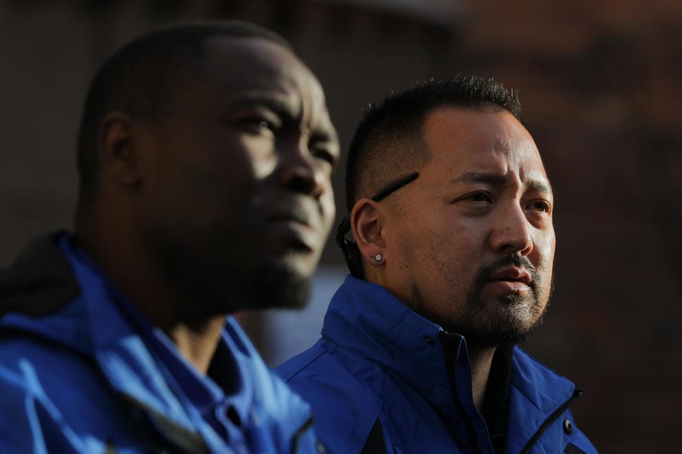 a close up portrait of community crisis responders Abdillahi Mohamed, left, and Chris Inaba