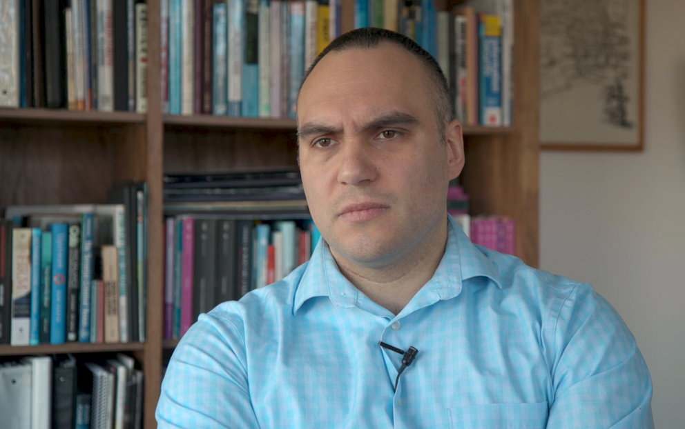 Cyrus Donato sits for an interview in a light blue shirt
