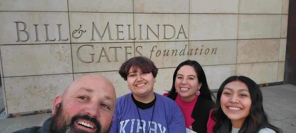 Counselor Enrique Tarver and a group of students in front of the Gates Foundation