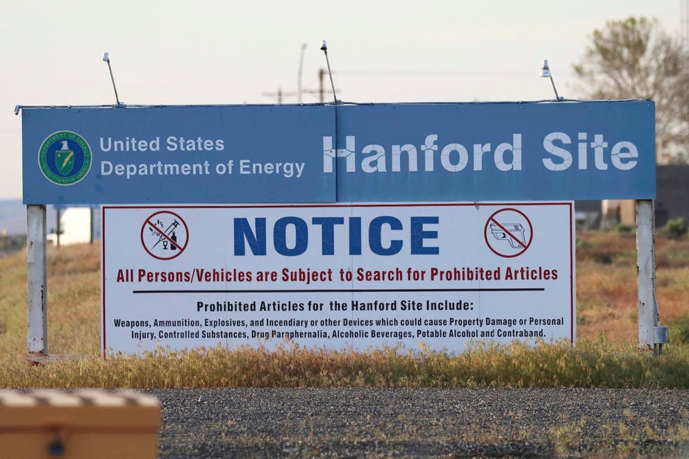 signs are posted at an entrance to the Hanford Nuclear Reservation in Richland, Wash.