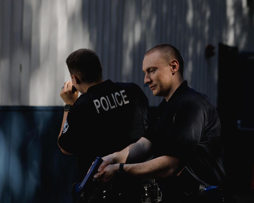 New police recruits practice clearing a building.