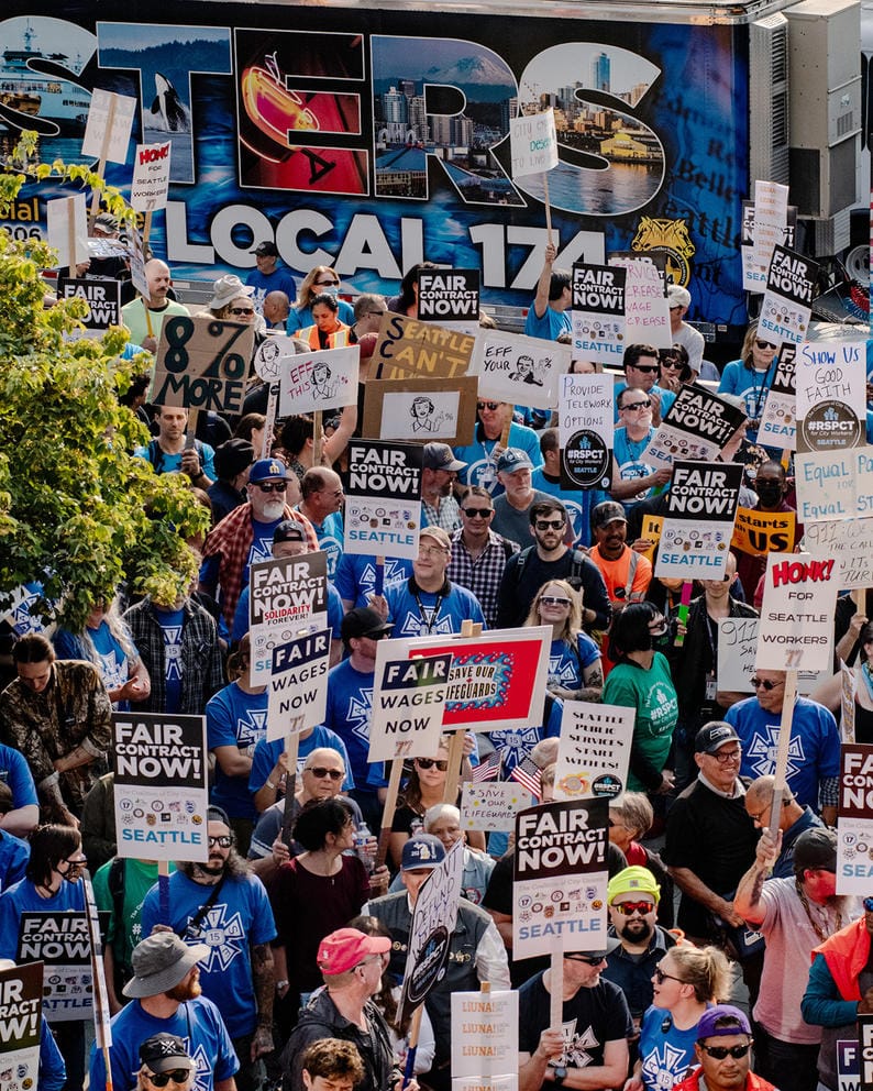 a crowd of people holding signs