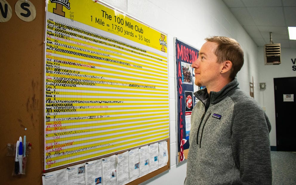 A person studies a chart on a wall that is labeled