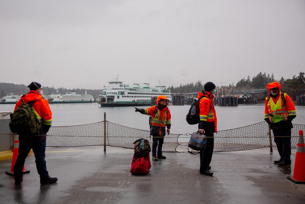 Washington State Ferries workers prepare to arrive at the Bainbridge Island ferry terminal on the Seattle-Bainbridge Island ferry.