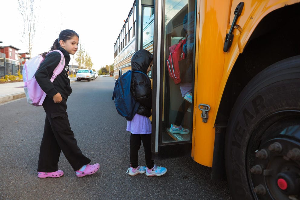 Sama Heyadee, 9, boards the bus to Parkside Elementary, May 1, 2024. (Genna Martin/Cascade PBS) (Genna Martin/Crosscut)