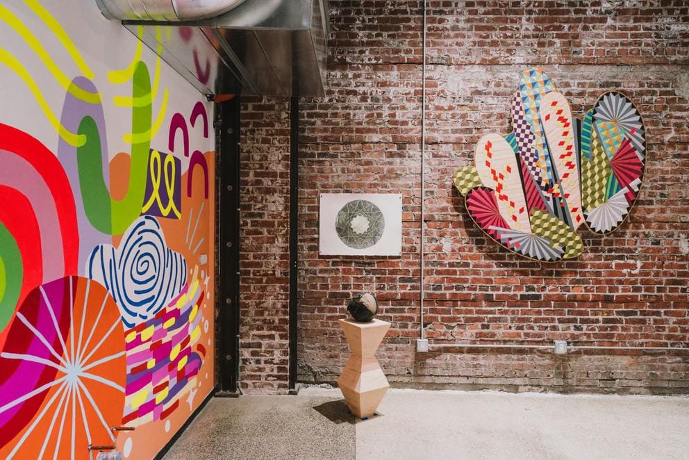 An art gallery with a brick wall