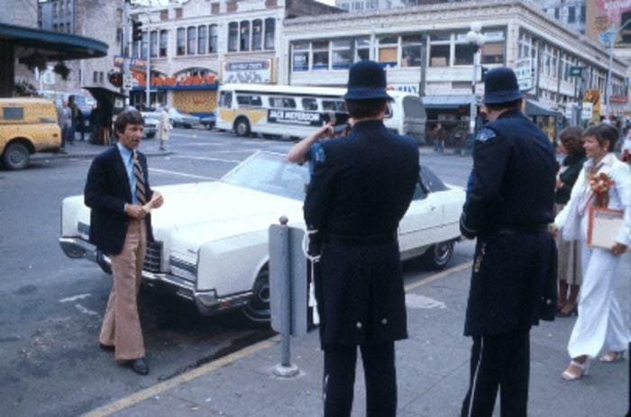 A person faces two police officers.