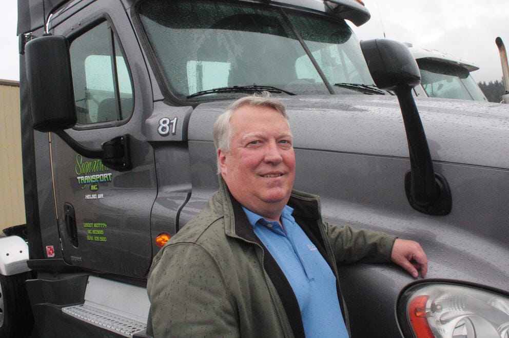 Dale Lemmons in front of one of his trucks