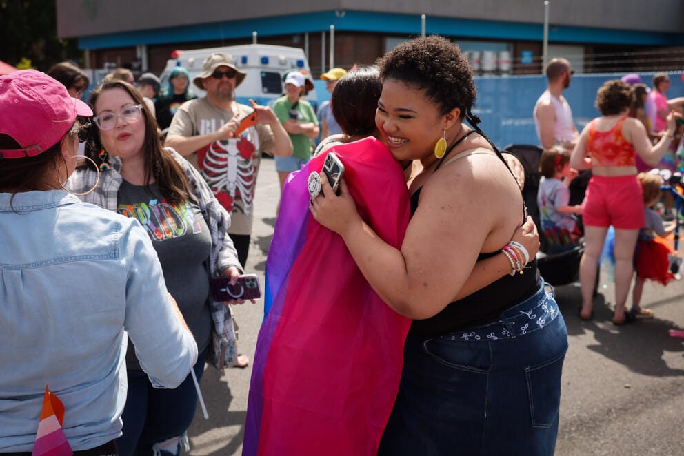 Two people hug in a crowd