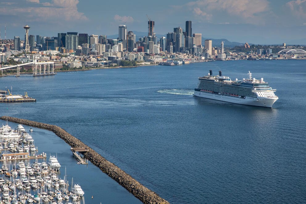 An aerial view of a cruise ship leaving a port in Seattle