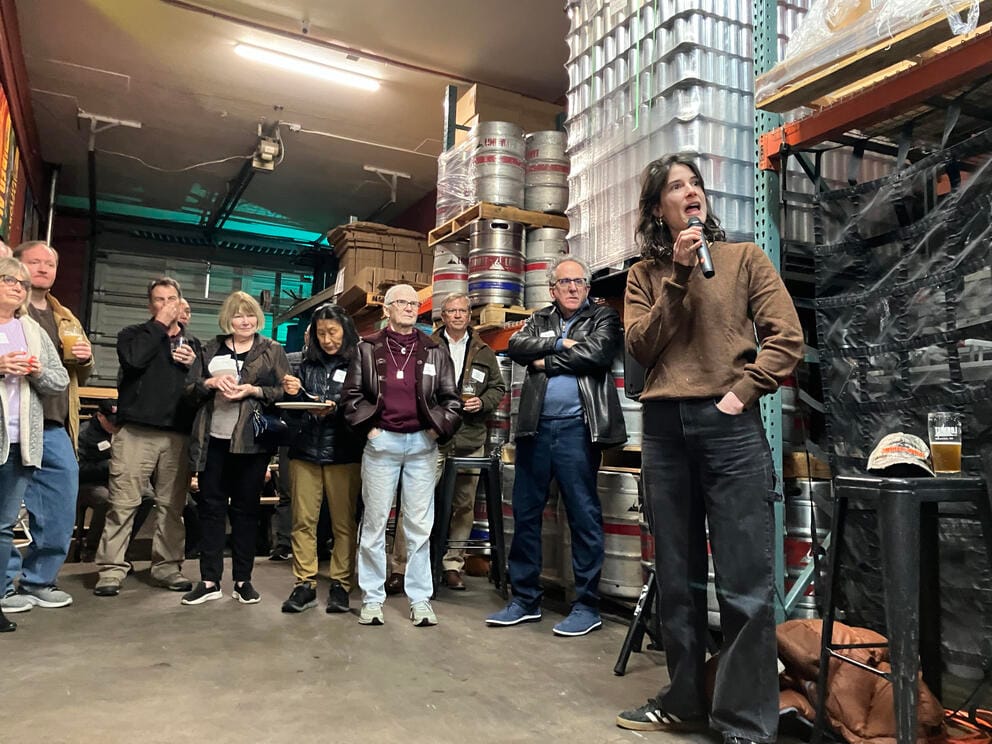 A crowd of people watch as Marie Gluesenkamp Perez speaks at Loowit Brewing in Vancouver.