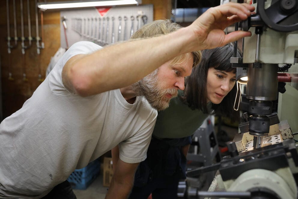 U.S. Rep. Marie Gluesenkamp Perez, right, and her husband Dean Glusenkamp, work on a cylinder head in the auto body shop they own in Portland.