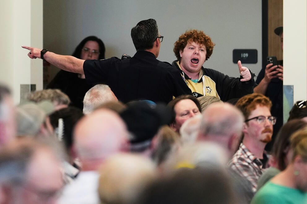A protester is pulled away from the crowd and arrested during a town hall event with Rep. Marie Gluesenkamp Perez, D-Wash., at Centralia College.