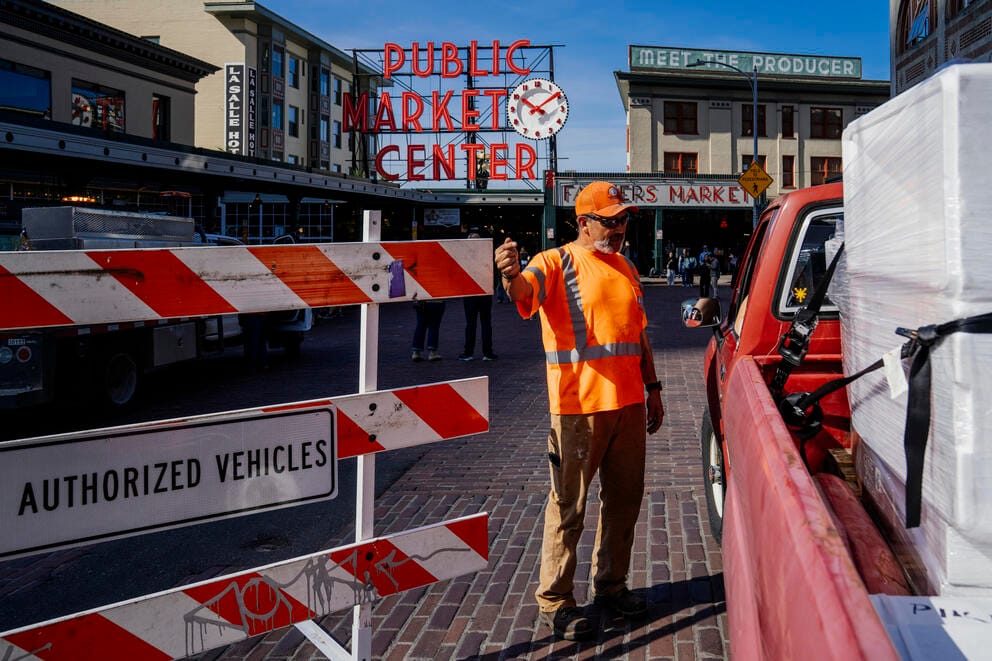 SDOT worker Cid Rodriguez moves a temporary barrier 